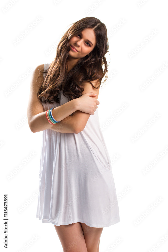 Young woman in white sundress. Slim girl with crossed arms. Model in romantic pose. Apparel emphasizes natural beauty. Young woman in white sundress. Slim girl with crossed arms. Model in romantic pose. Apparel emphasizes natural beauty.