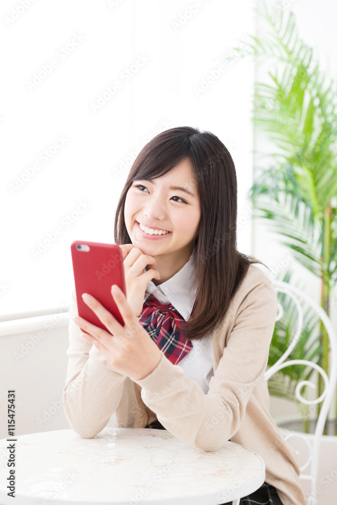 asian schoolgirl using smart phone in the cafe asian schoolgirl using smart phone in the cafe