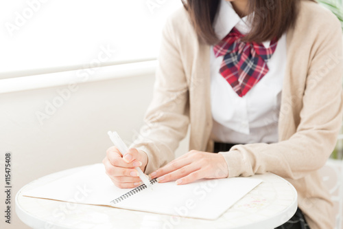 asian schoolgirl studying in the cafe