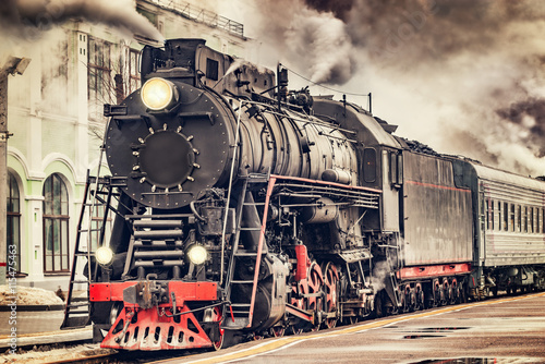 Obraz na płótnie Retro steam train departs from the station.