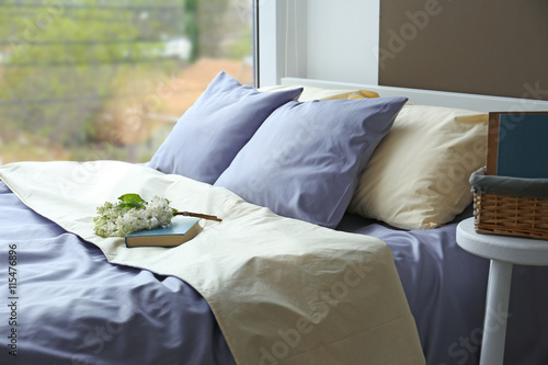 Made-up bed with blue bed l...
