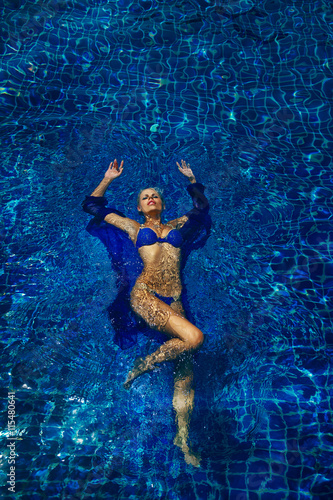 fashion photo of sexy beautiful girl in blue bikini relaxing in