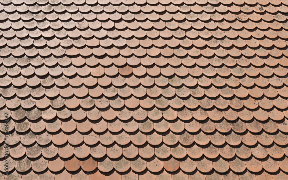 Brown tile roof in sunny day as background Brown tile roof in sunny day as background
