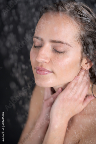 a woman standing at the shower