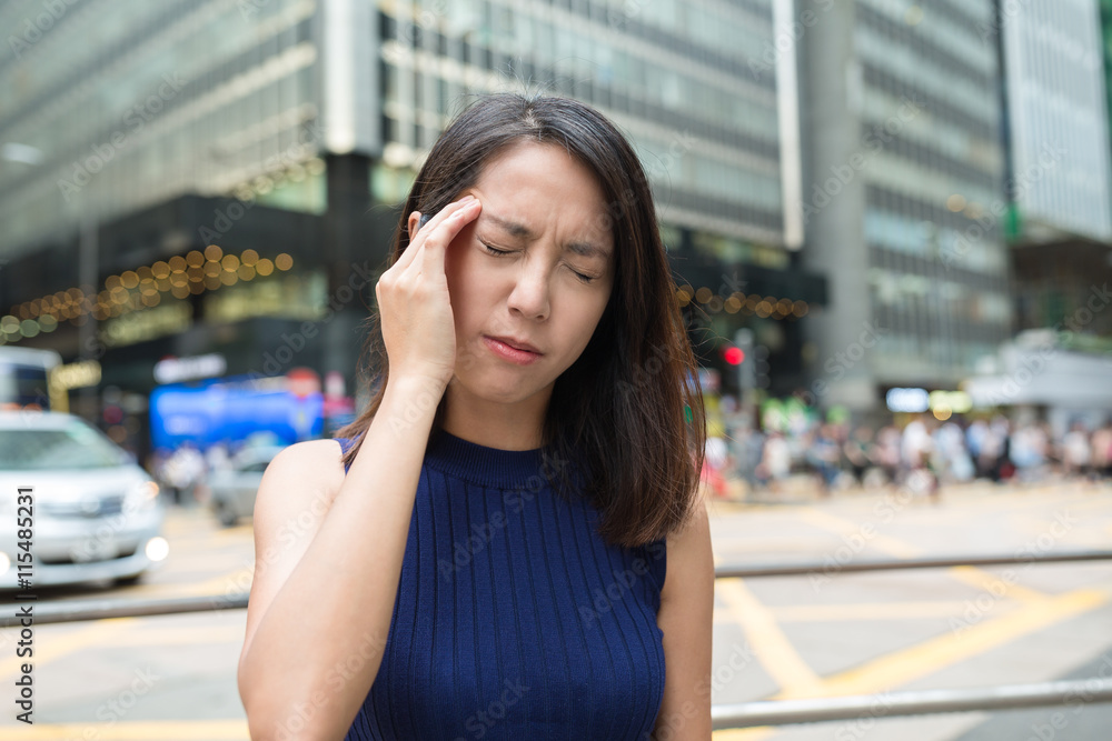 Woman feeling headache at outdoor in Hong Kong