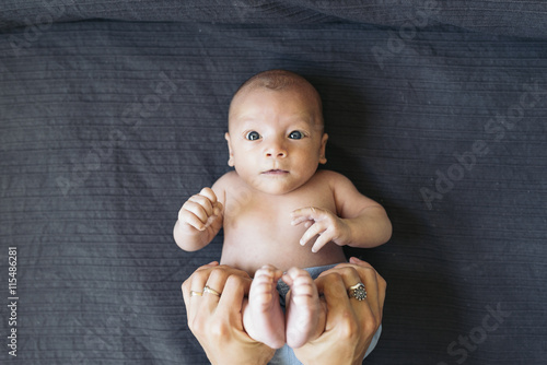 Mother Burping Her Little Newborn Baby photo