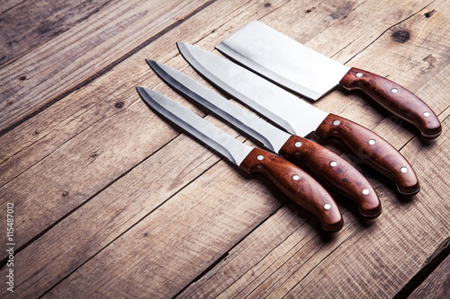 Beautiful knives with wooden handle, on an old table. Kitchen, c