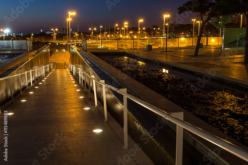 lighted walkway with a fountain on each side
