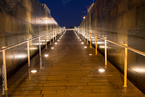 lighted walkway with a fountain on each side