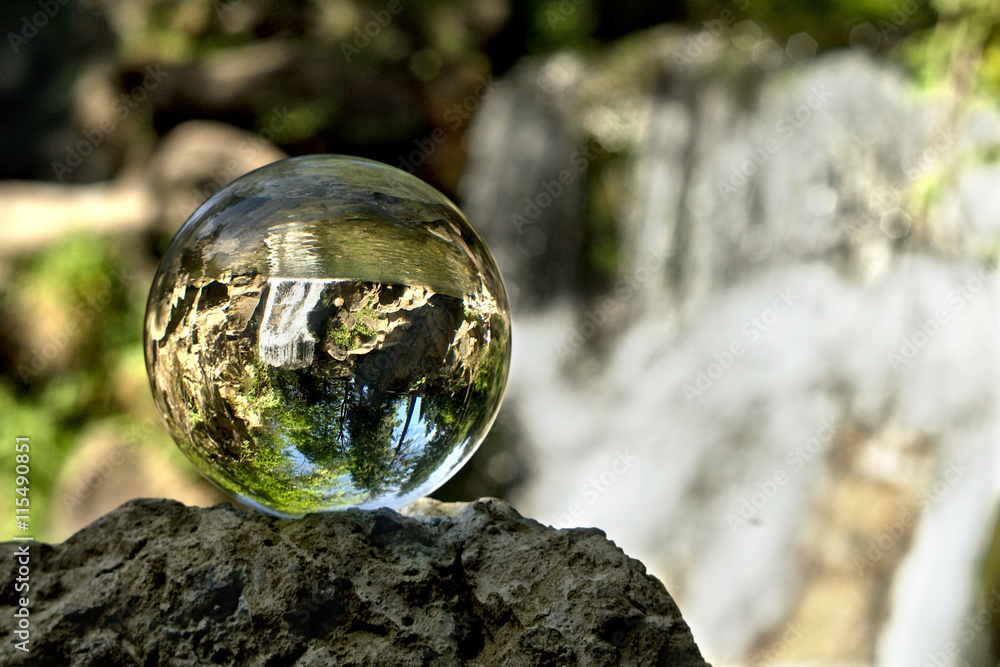 Fototapeta premium Mountain waterfall in crystal ball