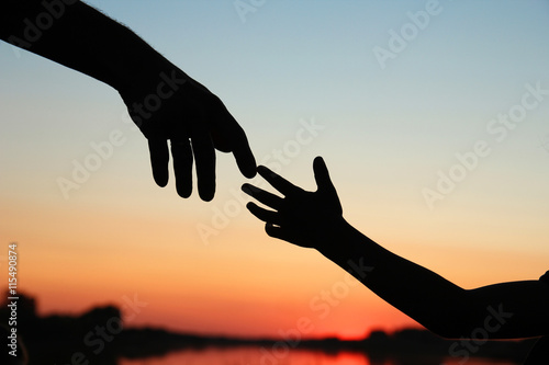 silhouette parent and child hands photo
