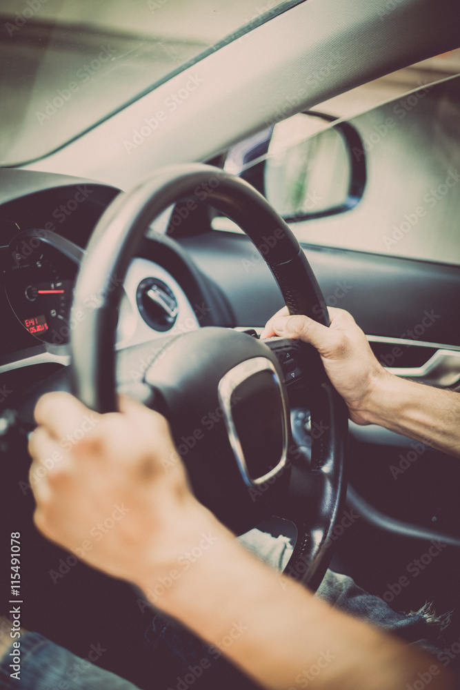 Naklejka premium Hands on steering wheel