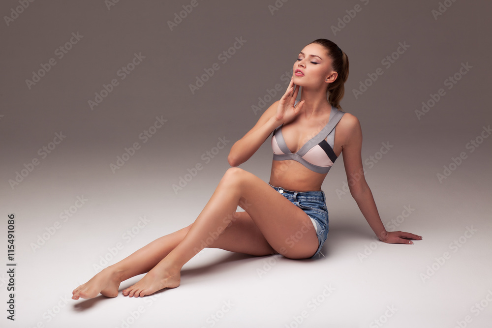 sexy woman in shorts and lingerie on a gray gradient background, aroused body sexy woman in shorts and lingerie on a gray gradient background, aroused body