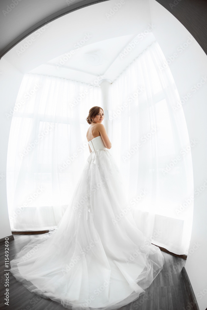 Brides beauty. Young woman in wedding dress indoors Brides beauty. Young woman in wedding dress indoors