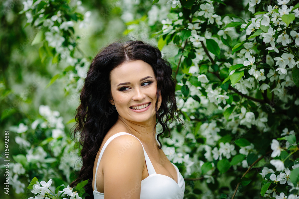 Young brunette woman portrait in blooming apple tree park Young brunette woman portrait in blooming apple tree park