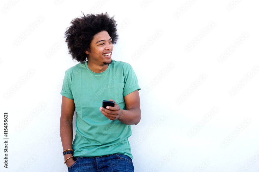 Smiling young black man holding cellphone Smiling young black man holding cellphone