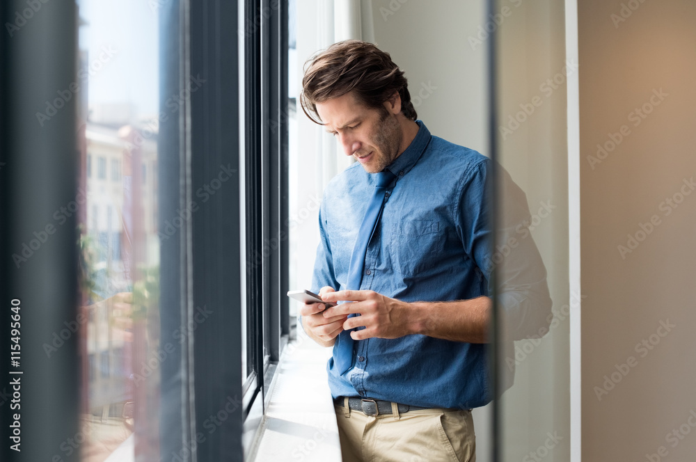 Businessman texting a message Businessman texting a message
