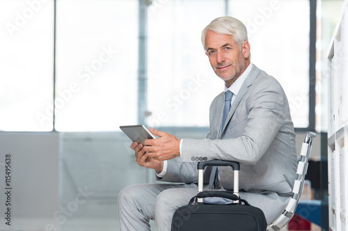 Happy senior businessman traveling