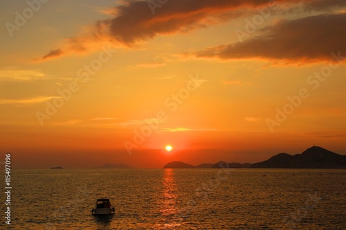 Boat in sea at sunset