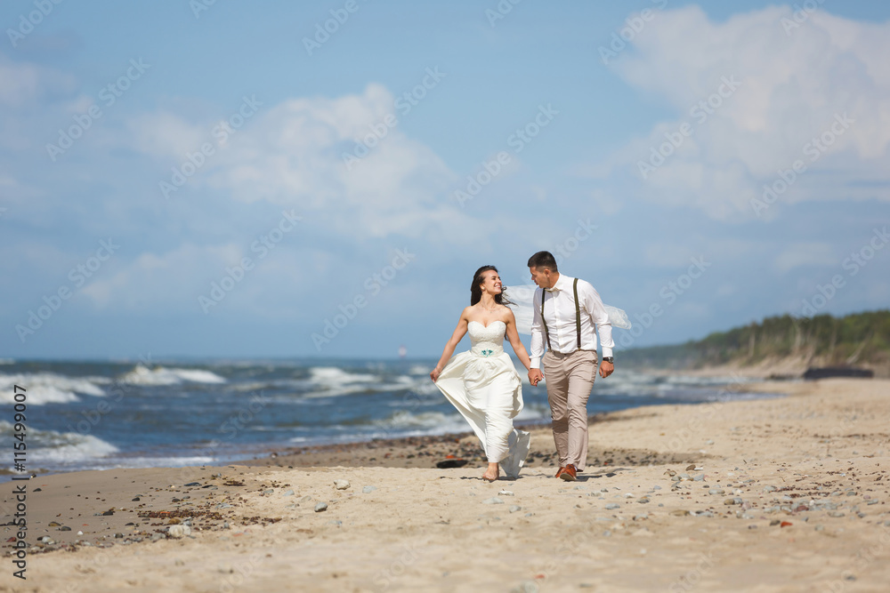 Cheerful wedding couple on the beach Cheerful wedding couple on the beach