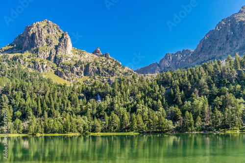 Mountains and reflections on waters in St.Maurici National Park (Catalonia, Spain). photo