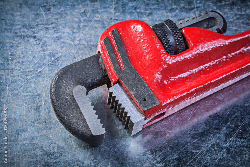 Monkey wrench on metallic background plumbing concept Monkey wrench on metallic background plumbing concept
