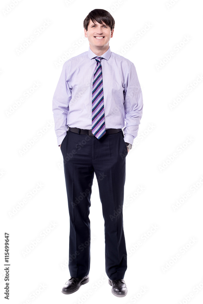 Corporate executive standing with hand sin pockets. Corporate executive standing with hand sin pockets.
