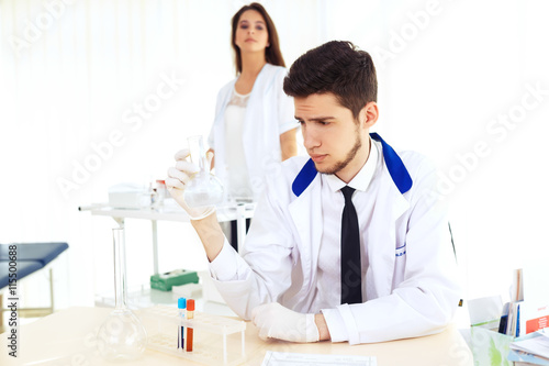 group of scientists working at the laboratory Laboratory concept with caucasian male chemist. Horizontal template for a poster  webpage or leaflet.  