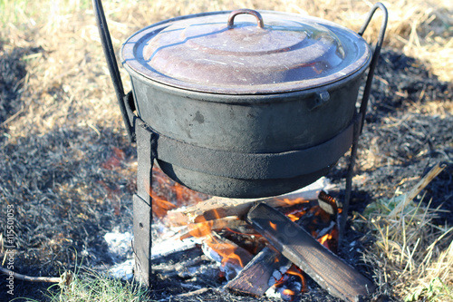Old camping boiling kettle cauldron on fire. Cooking in the nature.