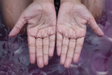 withered hands of young girl after swimming is long time
