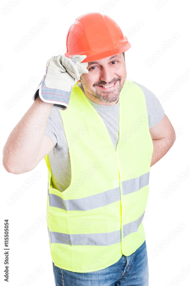 Attractive builder man holding helmet acting polite