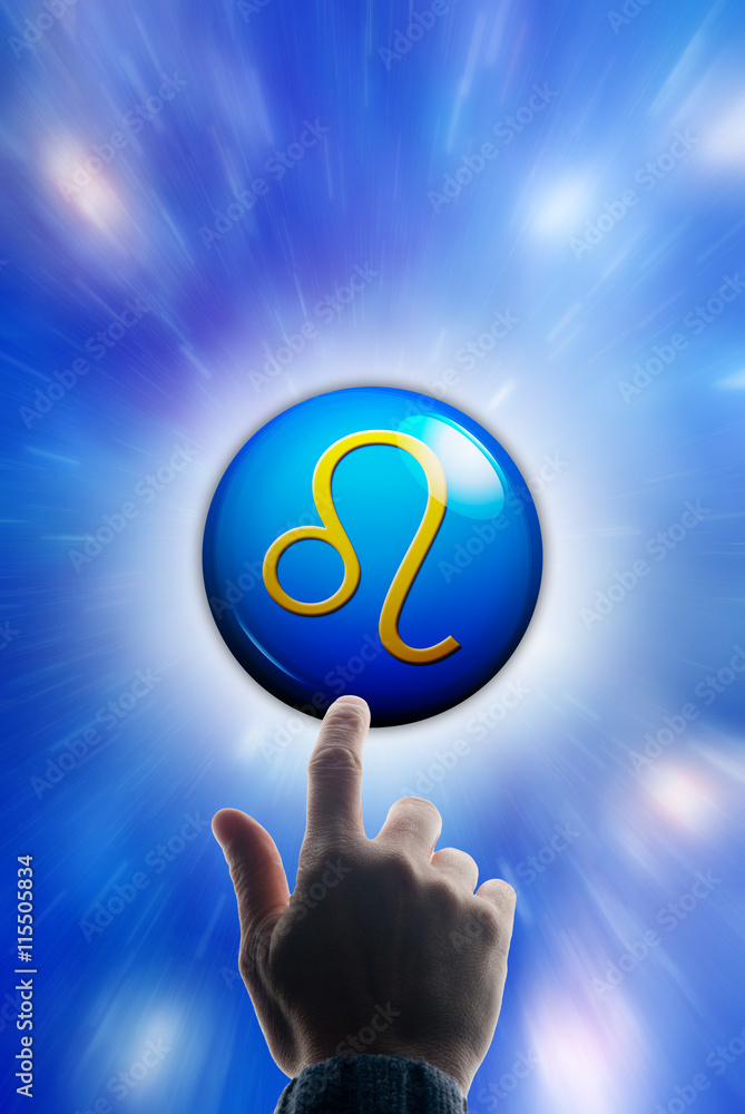 hand touching a button with the zodiac symbol of Leo hand touching a button with the zodiac symbol of Leo