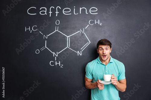 Εκτύπωση καμβά Surprised student drinking coffee over drawn structure of caffeine molecule