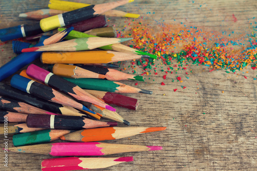 Artistic colorful accorded old pencils on the wooden background. photo