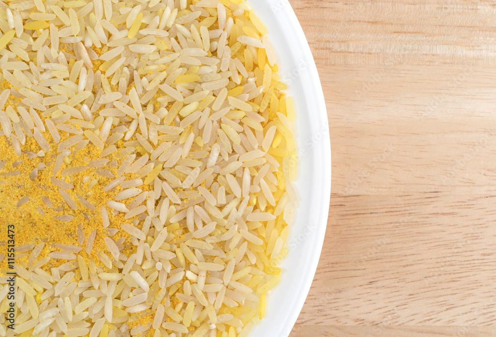 Saffron yellow rice on a white plate and table top. Saffron yellow rice on a white plate and table top.
