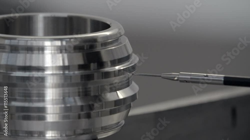 Coordinate measuring machine (CMM), inspecting a stainless steel component.