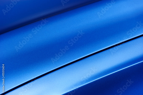 Surface of blue sport sedan car metal hood, part of vehicle bodywork, steel gradient line pattern 