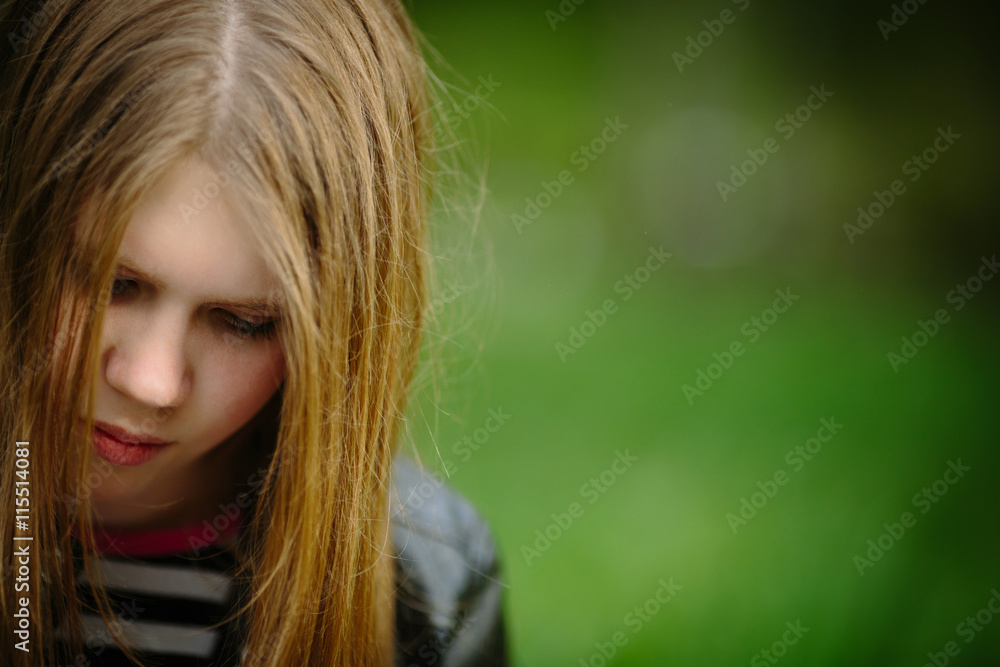 Portrait of alone thoughtful sadness girl is sad on the green background Portrait of alone thoughtful sadness girl is sad on the green background