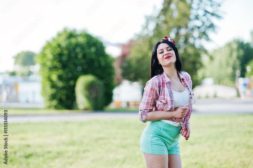 Portrait of style country girl on short green shorts and crossco Portrait of style country girl on short green shorts and crossco