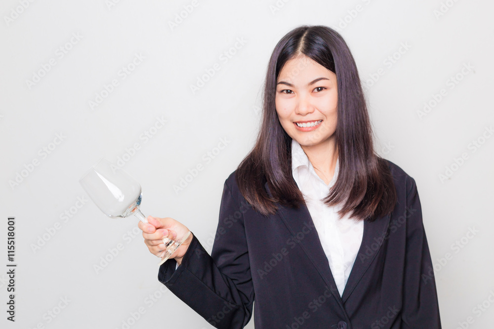 Beautiful asian business girl relax with glass of red wine for d Beautiful asian business girl relax with glass of red wine for d
