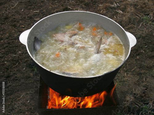 Delicious fish soup in the cauldron on the nature.