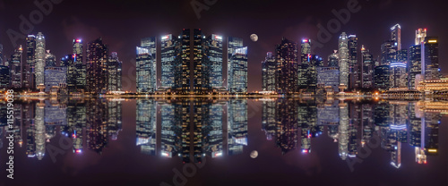 Panoramic view at night of a megalopolis skyscrapers with reflection of Singapore city.