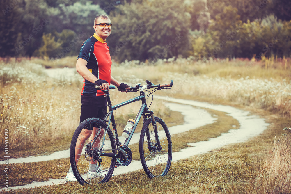 man cyclist rides in the forest on a mountain bike. man cyclist rides in the forest on a mountain bike.