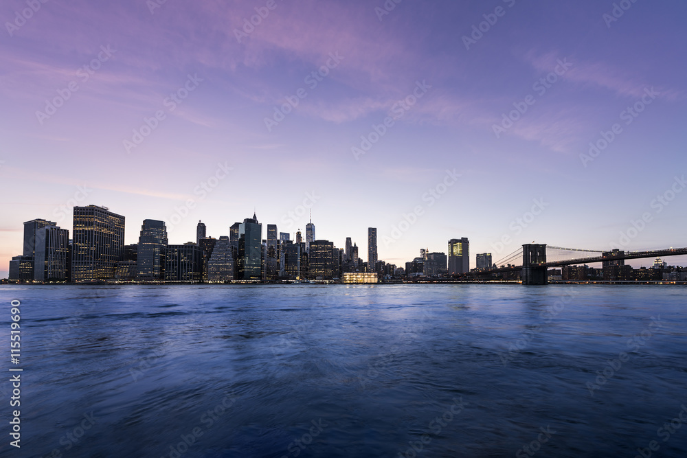 New York City Manhattan skyline and cityscape at twilight with Brooklyn Bridge 