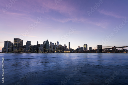 New York City Manhattan skyline and cityscape at twilight with Brooklyn Bridge 