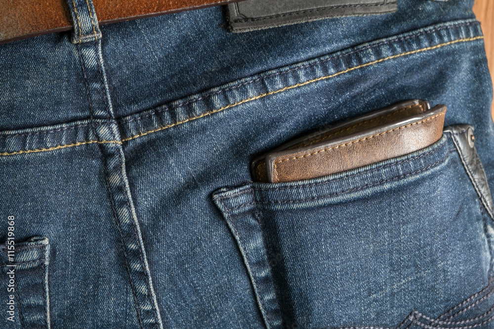 Leather wallet in back pocket of blue jeans