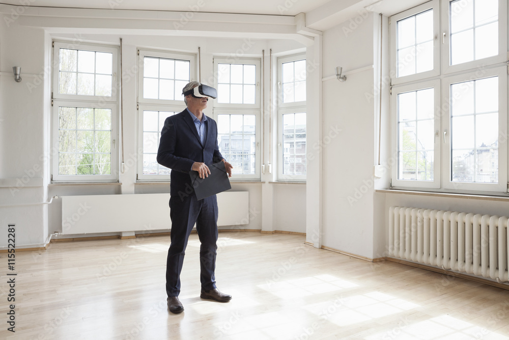Real estate agent wearing virtual reality glasses in empty apartment Real estate agent wearing virtual reality glasses in empty apartment