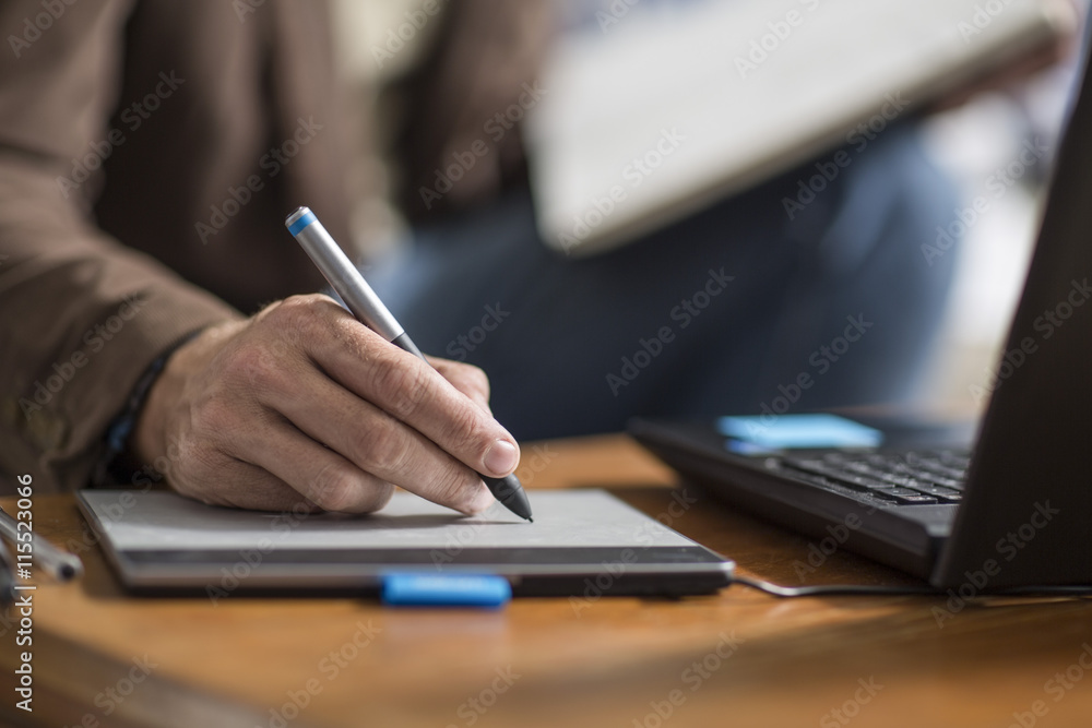 Hand of graphic designer, graphics tablet and pencil Hand of graphic designer, graphics tablet and pencil
