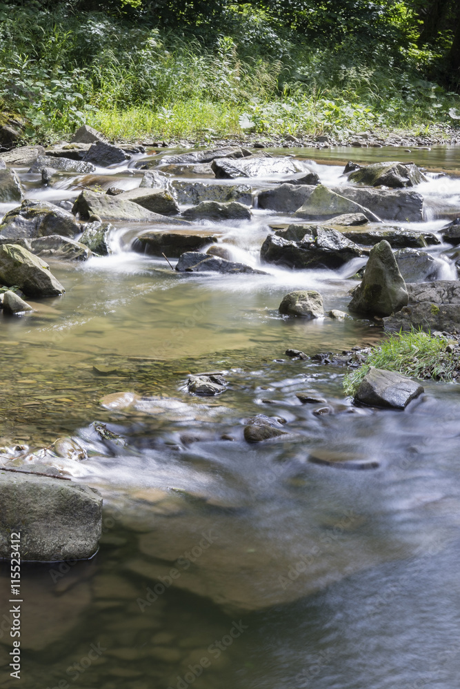 The river - flowing water between the rocks. The river - flowing water between the rocks.