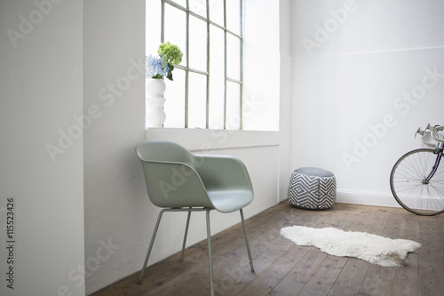 Modern home interior, chair and stool at window photo